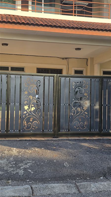 Gate with laser-cut floral panels in the sun